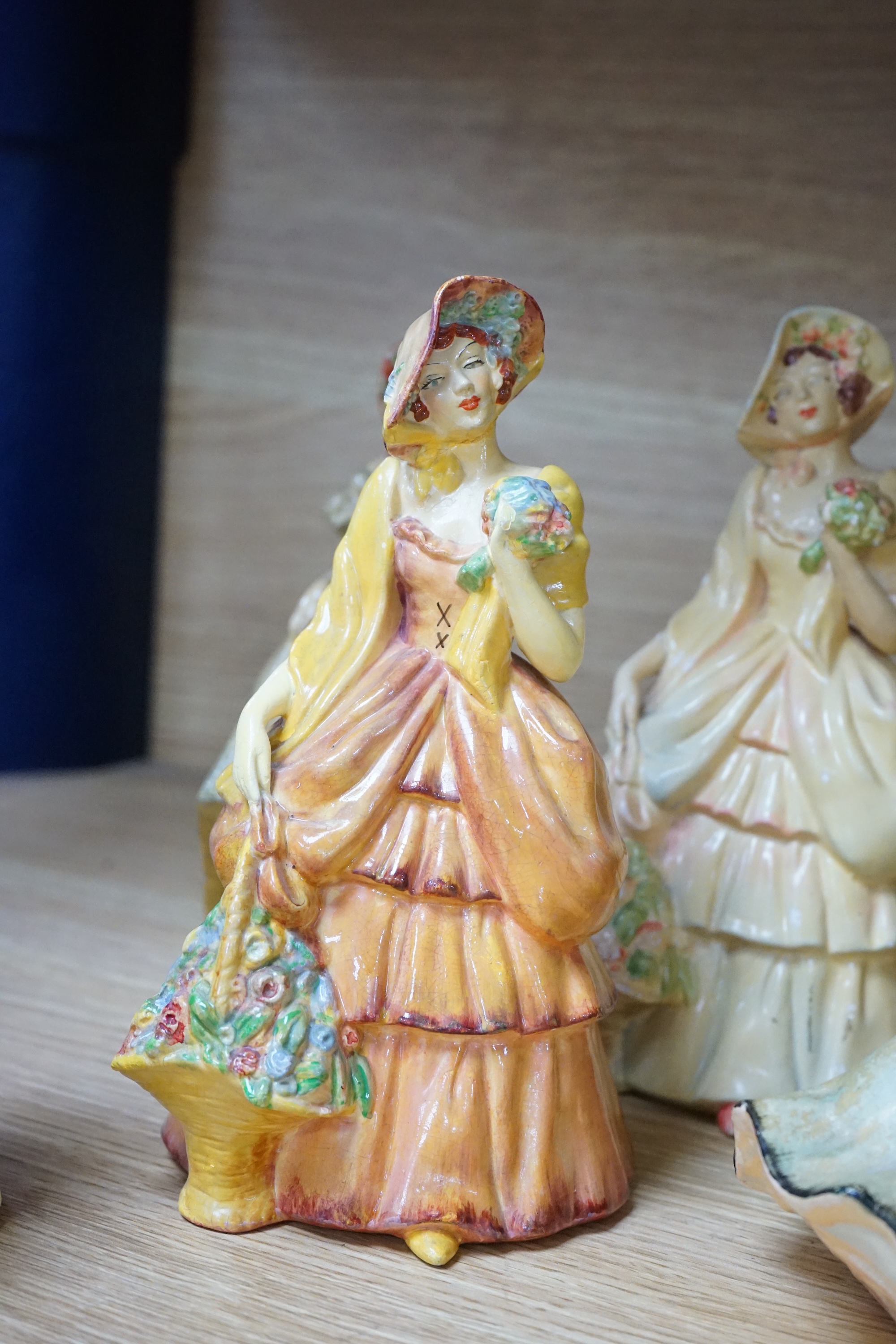 Nine Crown Devon 1930's dancers, in the manner of Wade figures, tallest 26cm high. Condition - fair to good